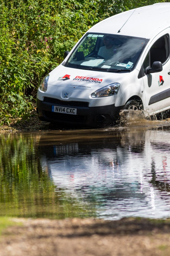 leaflet delivery van going through water